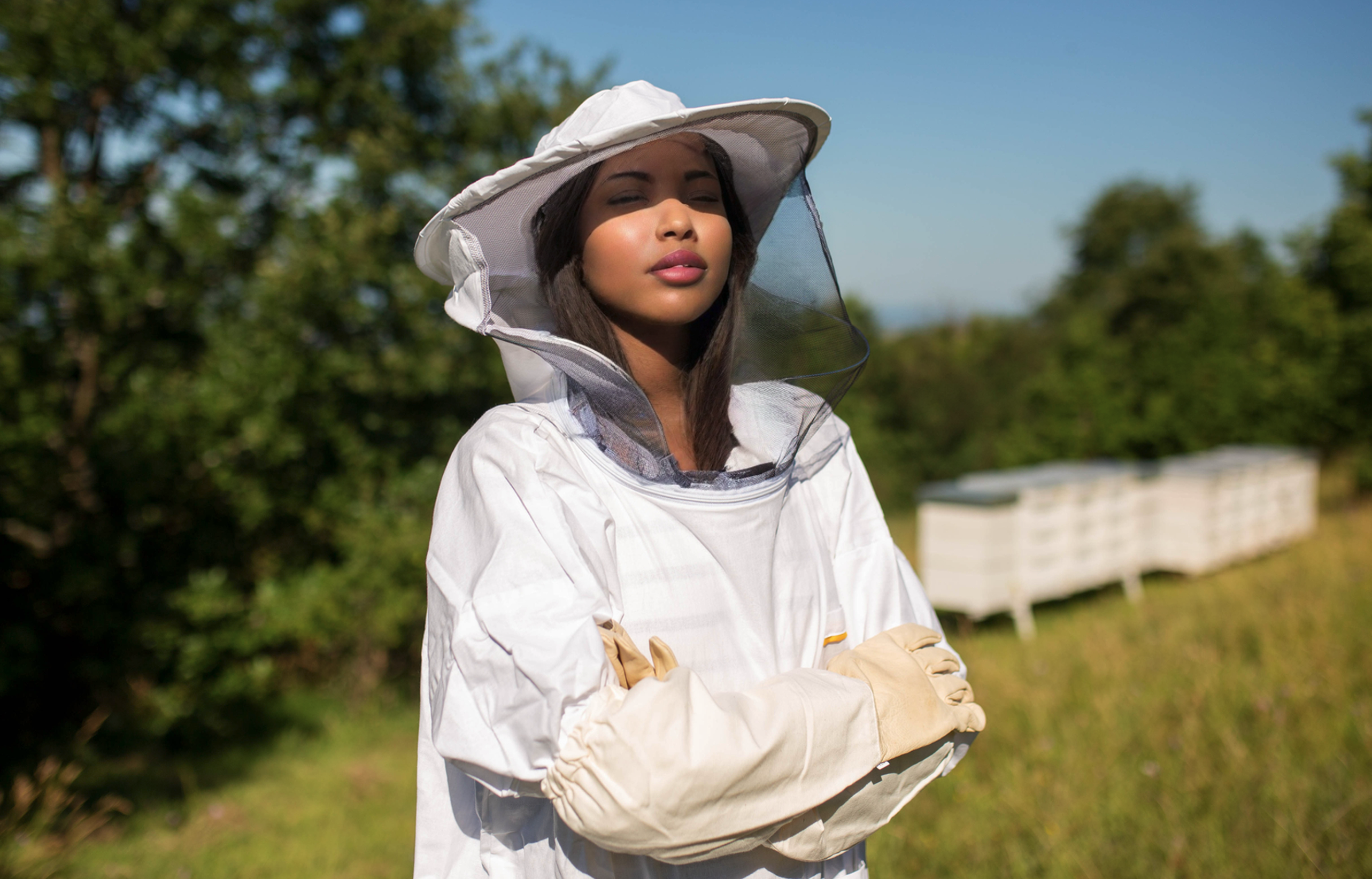 Woman in bee suit with folded arms